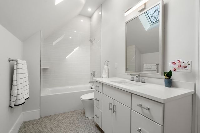 a bathroom with a double vanity sink toilet and shower