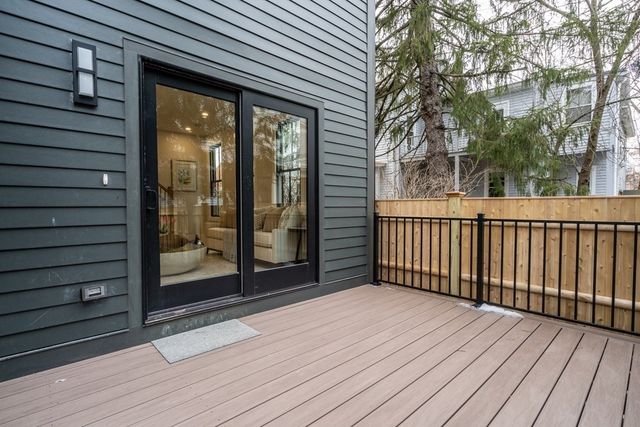 a view of a room with wooden floor and a floor to ceiling window