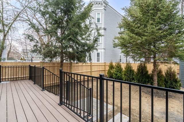 a view of a balcony with wooden floor and fence