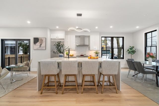 a dining room with stainless steel appliances kitchen island a table and chairs