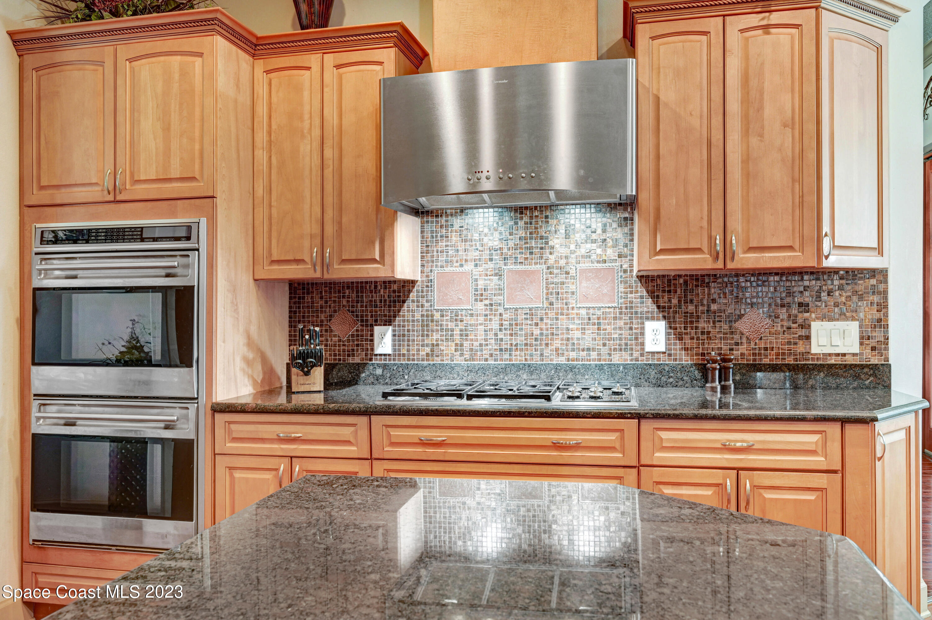 1317 Centennial Way Rockledge, FL 32955 - Photo 15 of 38 a kitchen with granite countertop a stove and cabinets
