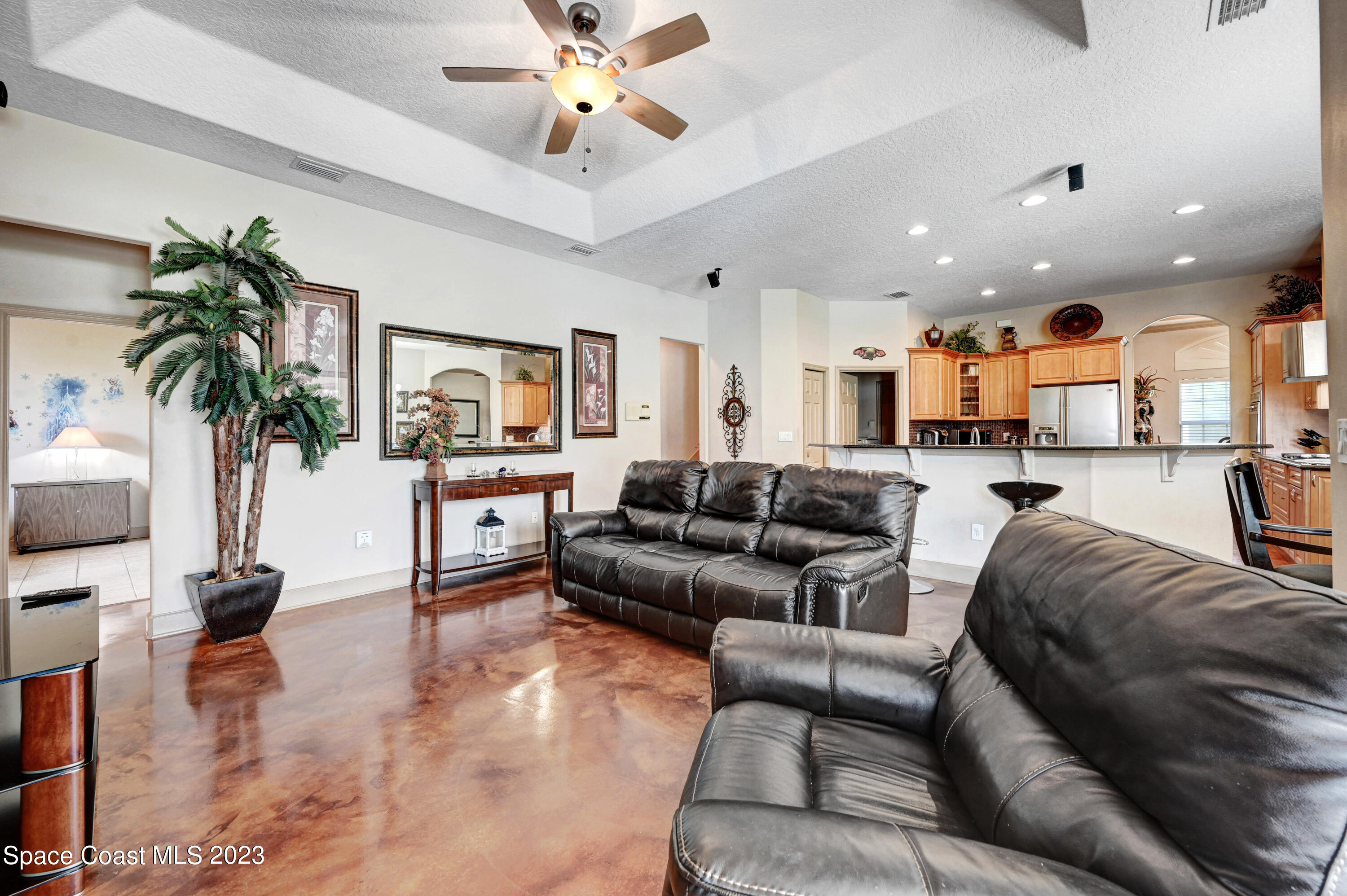 1317 Centennial Way Rockledge, FL 32955 - Photo 18 of 38 a living room with furniture and a chandelier