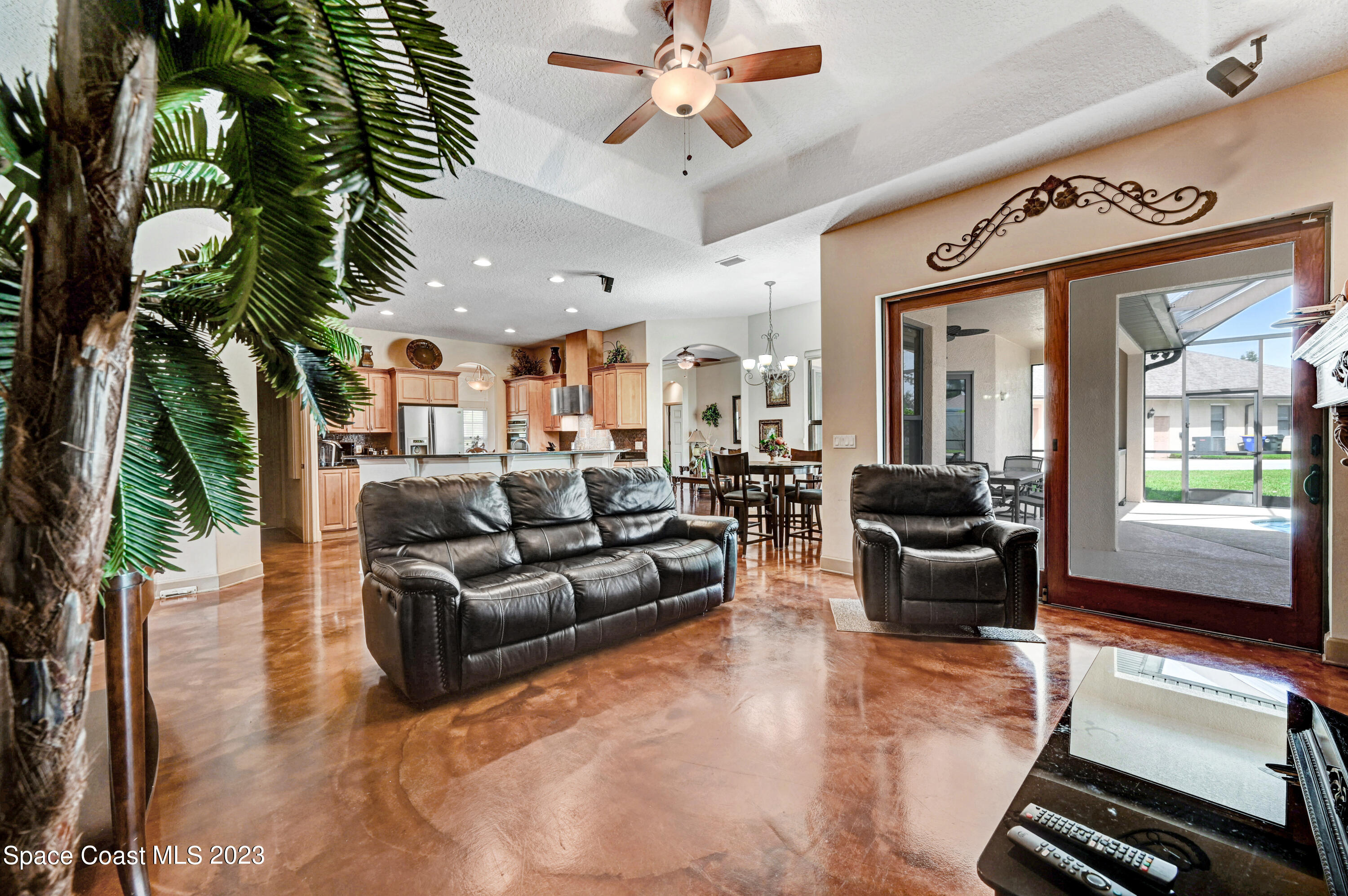 1317 Centennial Way Rockledge, FL 32955 - Photo 19 of 38 a living room with furniture ceiling fan and a rug