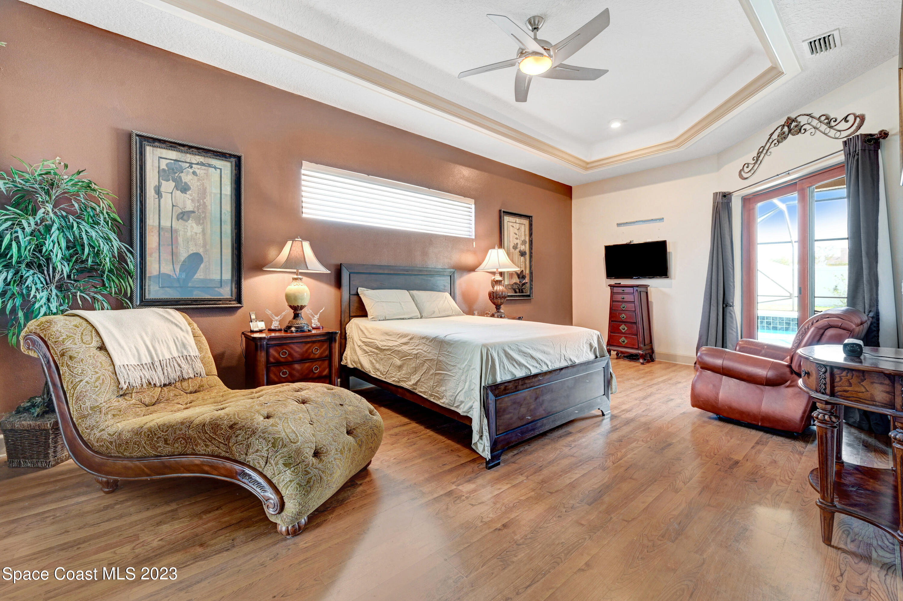 1317 Centennial Way Rockledge, FL 32955 - Photo 20 of 38 a bedroom with a bed couch and window