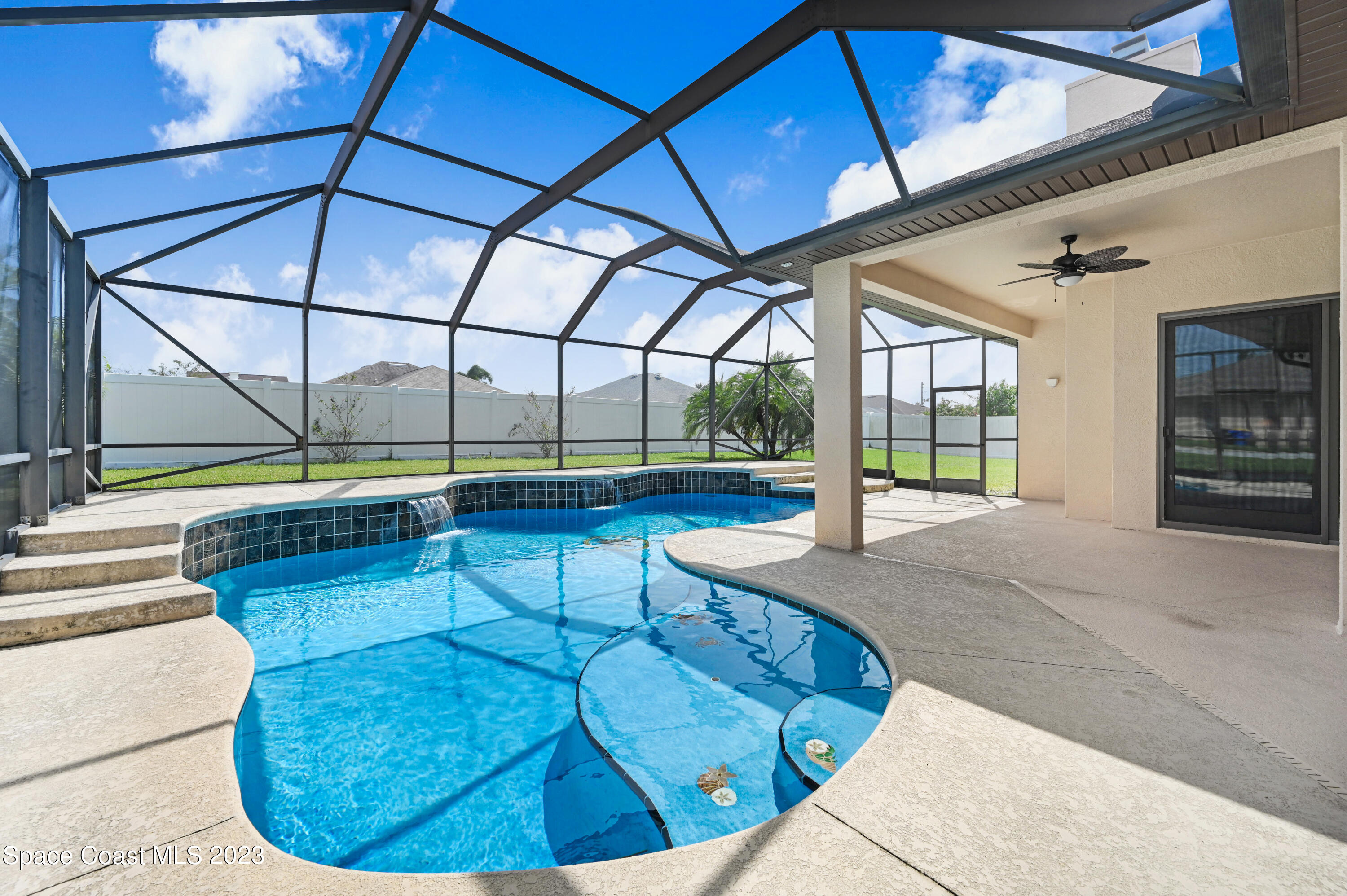 1317 Centennial Way Rockledge, FL 32955 - Photo 2 of 38 a view of a swimming pool with a lounge chair