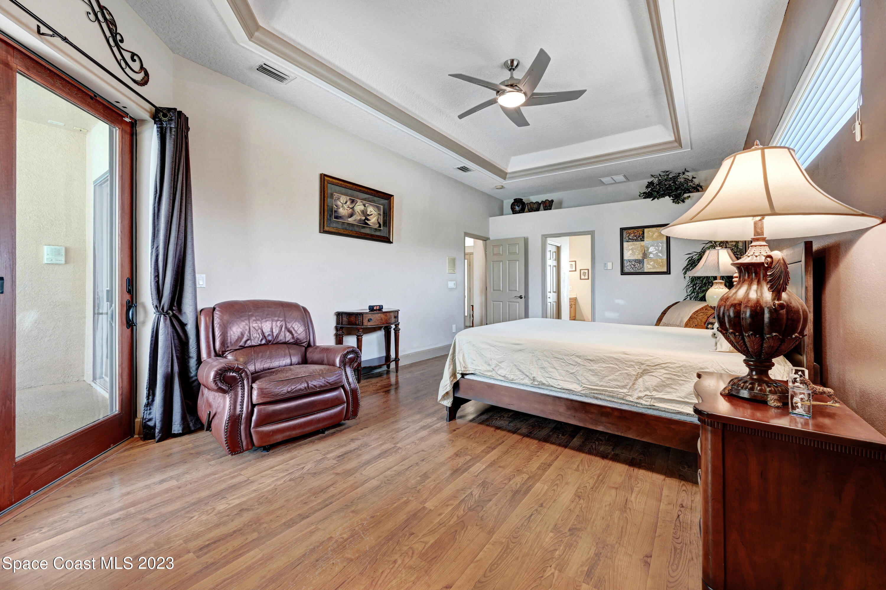 1317 Centennial Way Rockledge, FL 32955 - Photo 22 of 38 a bedroom with a bed couch and window