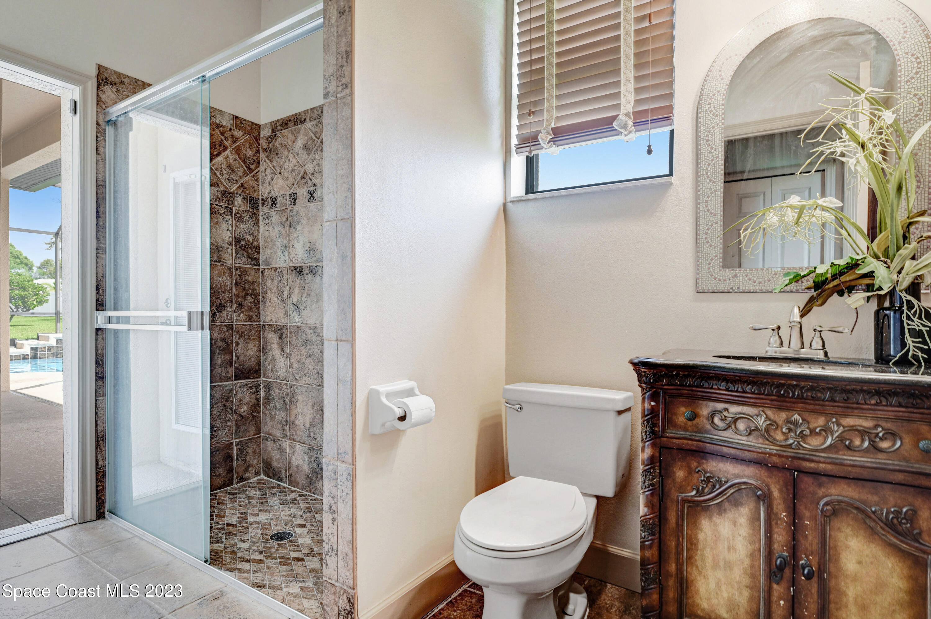 1317 Centennial Way Rockledge, FL 32955 - Photo 25 of 38 a bathroom with a toilet a sink and shower