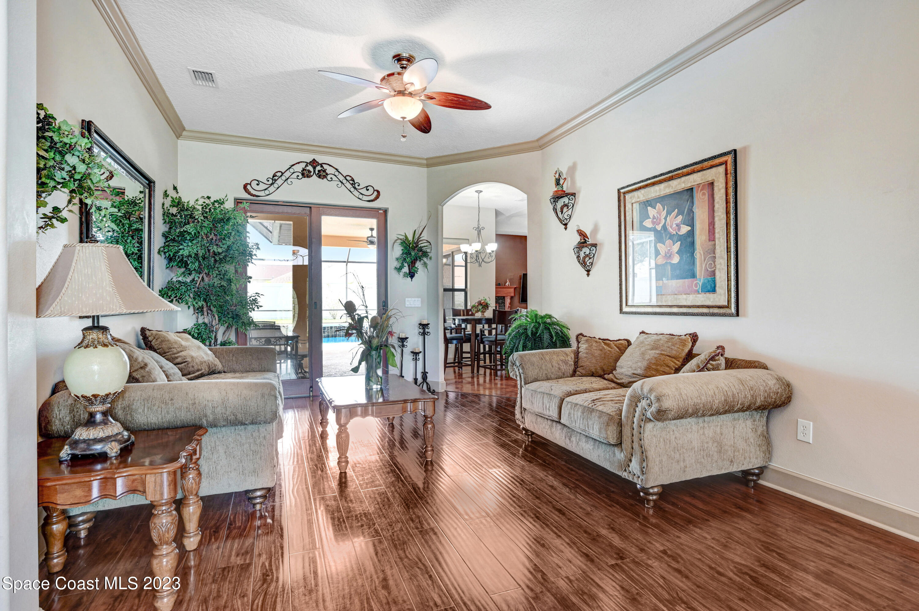 1317 Centennial Way Rockledge, FL 32955 - Photo 3 of 38 a living room with furniture and wooden floor