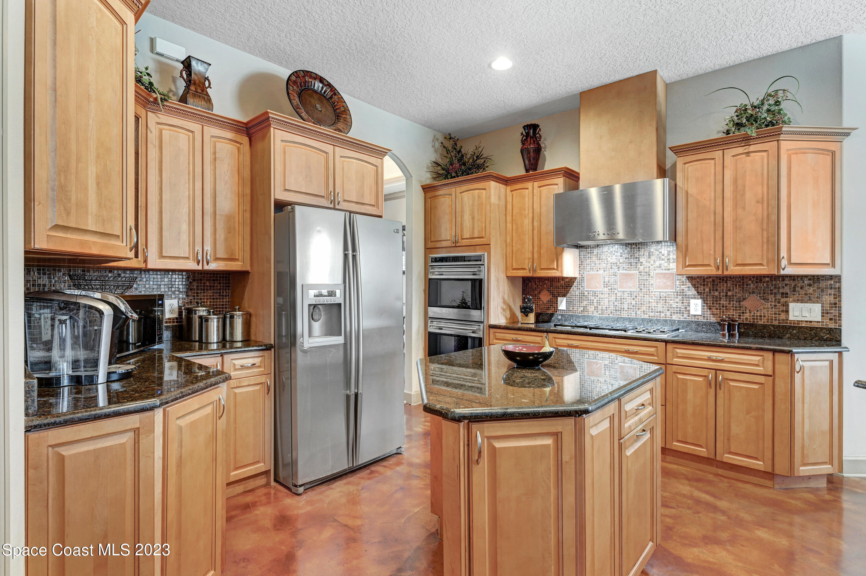 1317 Centennial Way Rockledge, FL 32955 - Photo 9 of 38 a kitchen with stainless steel appliances granite countertop a refrigerator a stove a sink and a microwave