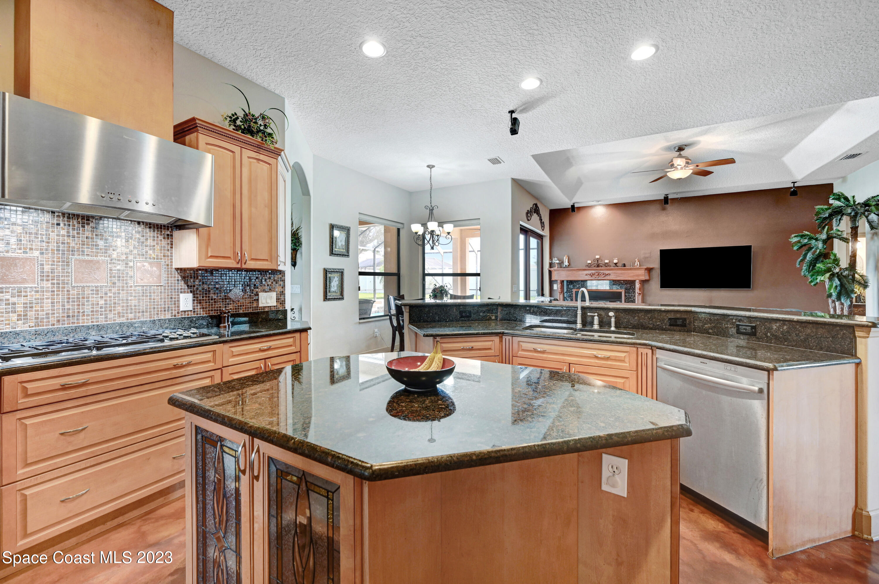 1317 Centennial Way Rockledge, FL 32955 - Photo 10 of 38 a kitchen with stainless steel appliances granite countertop a sink a stove and a wooden cabinets