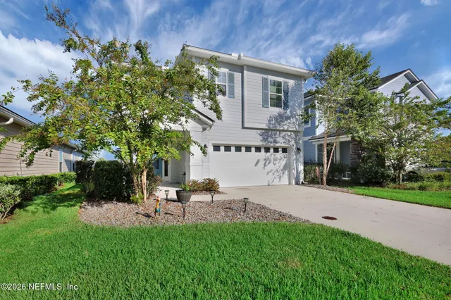 a front view of a house with a yard and garage