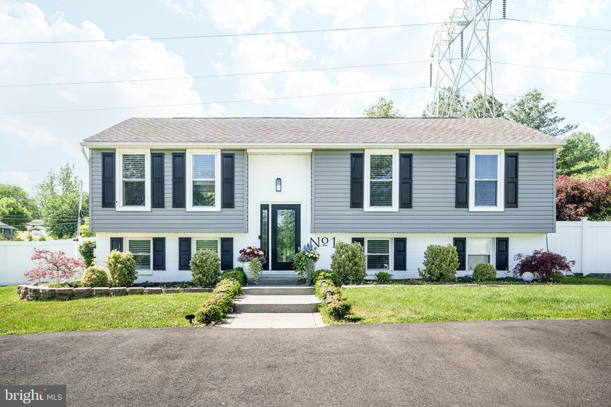 Front exterior of home with paved driveway