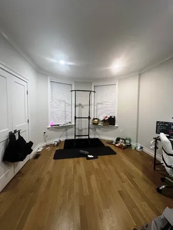 a room with gym equipment and a large window