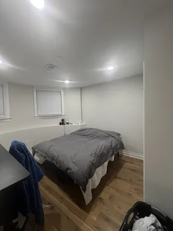 a bed sitting in a room next to a lamp