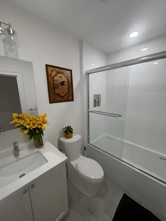 a bathroom with a sink a toilet and shower