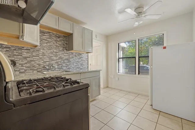 a kitchen with a stove a sink and a refrigerator