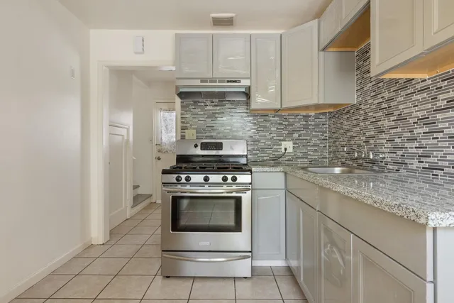 a kitchen with cabinets stainless steel appliances and a sink