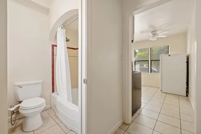 a bathroom with a toilet a sink and shower