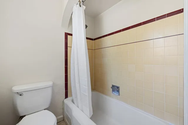 a bathroom with a toilet and a shower