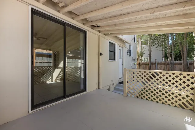 a bedroom with sliding door and wooden floor