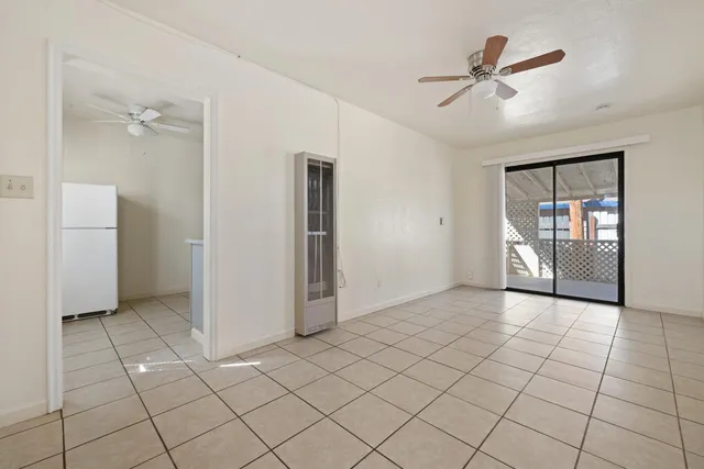 a view of a livingroom with wooden floor and a ceiling fan