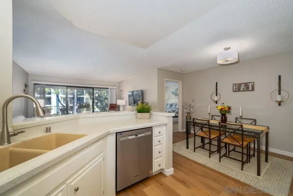 a kitchen with sink cabinets and dining table