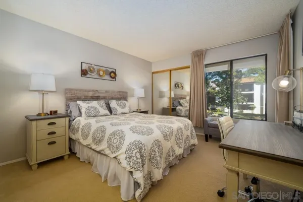 a bedroom with bed and large window
