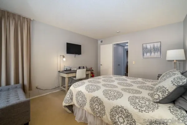 a bedroom with a bed and a television