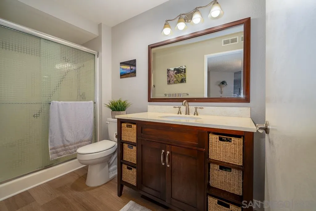 17617 Pomerado Road, Unit 215 San Diego, CA 92128 - Photo 23 of 57 a bathroom with a sink a toilet and mirror
