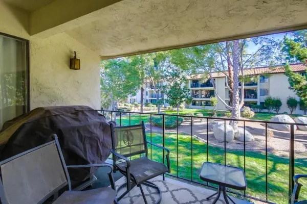 a view of a backyard with plants and a patio