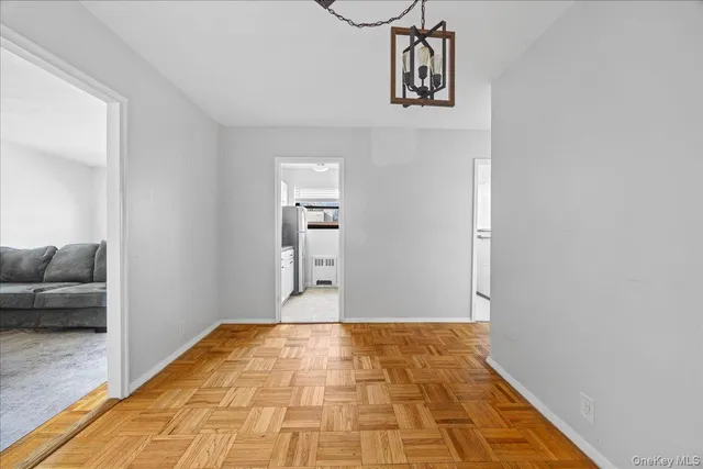 a view of room with window and wooden floor