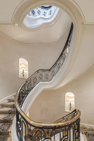 a living room with furniture flowers and a chandelier