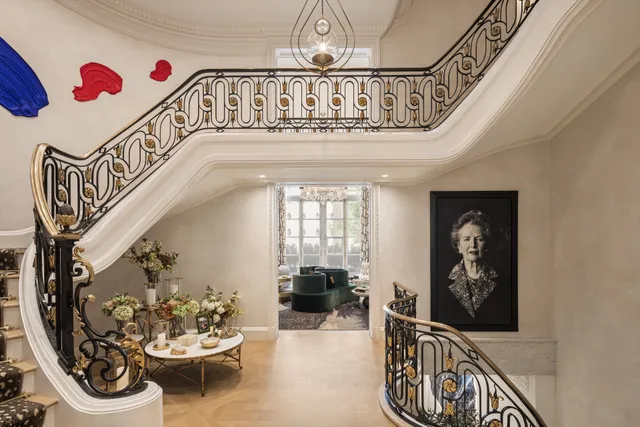 a kitchen with a dining table chairs sink and white cabinets