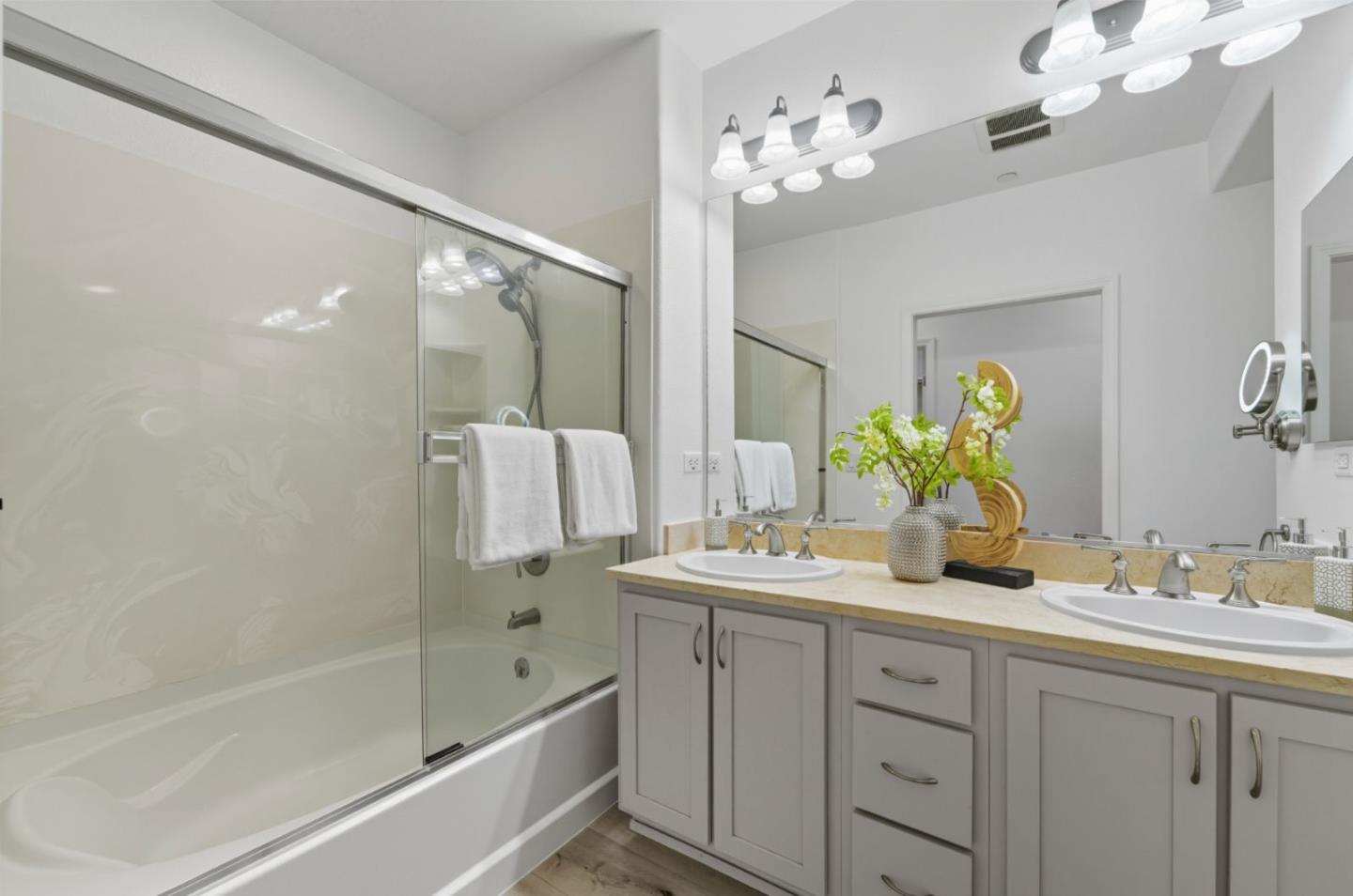 1388 Broadway, Unit 201 Millbrae, CA 94030 - Photo 13 of 33 a bathroom with a double vanity sink mirror double and shower