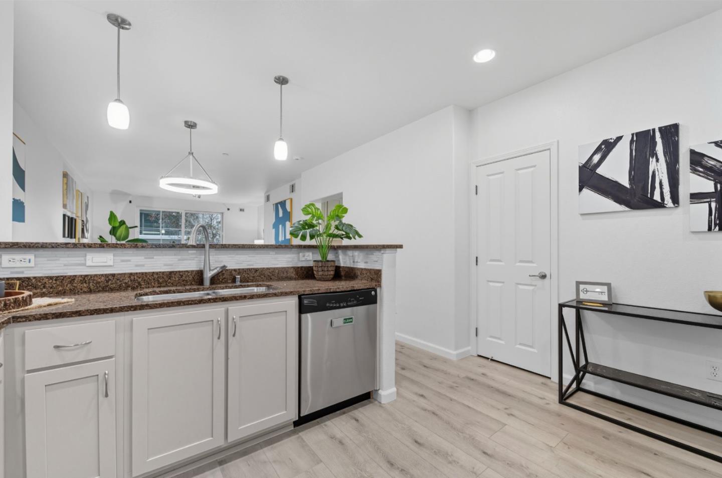 1388 Broadway, Unit 201 Millbrae, CA 94030 - Photo 5 of 33 a kitchen with granite countertop a sink a counter space appliances and cabinets