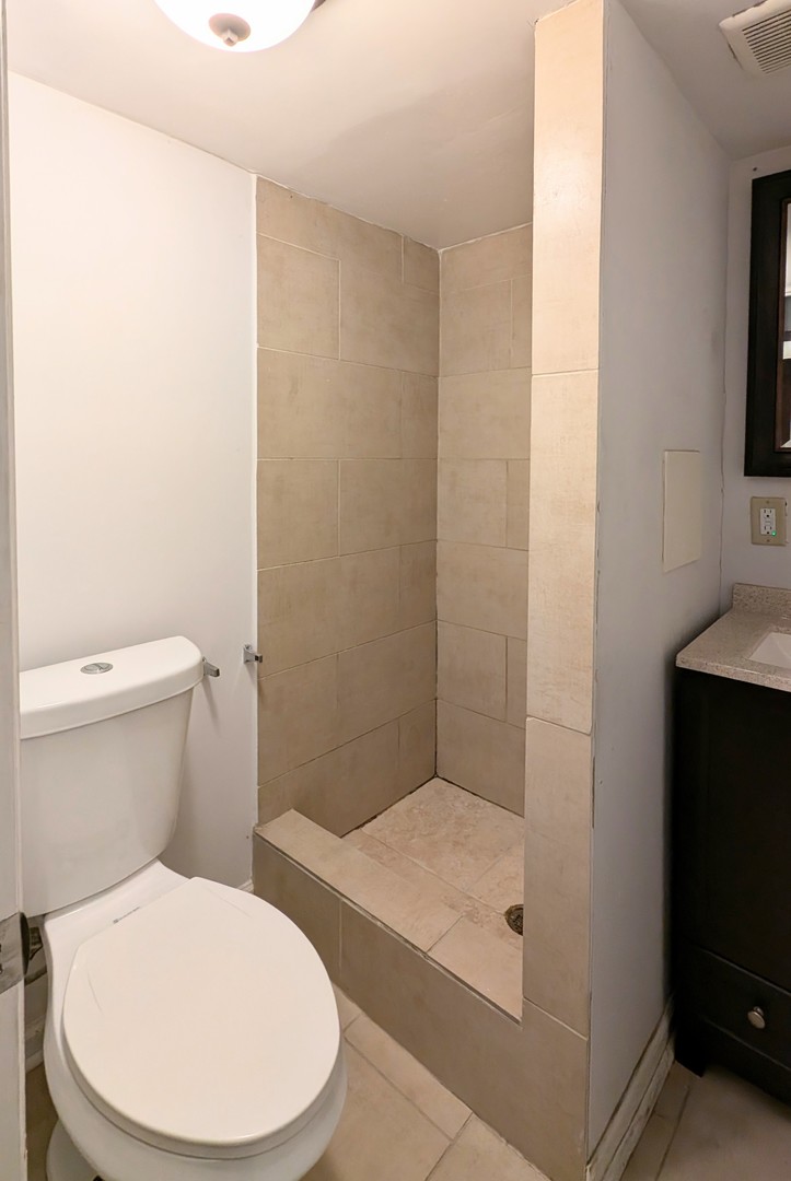 1710 North Raynor Avenue Crest Hill, IL 60403 - Photo 7 of 8 a bathroom with a toilet and a shower