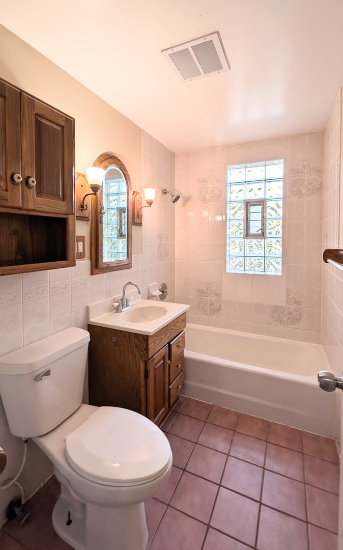 1710 North Raynor Avenue Crest Hill, IL 60403 - Photo 8 of 8 a bathroom with a sink toilet vanity and bathtub