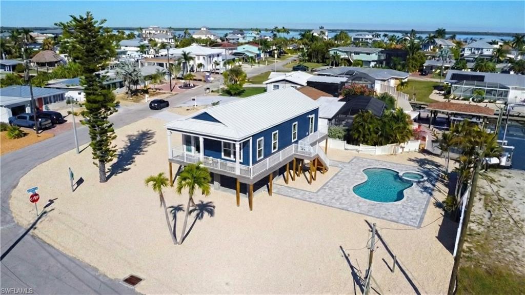 1 Fairview Boulevard Fort Myers Beach, FL 33931 - Photo 47 of 48 an aerial view of a house with swimming pool and large trees