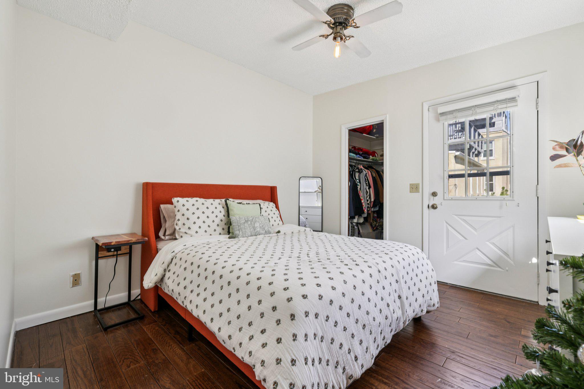 617 South Durham Street Baltimore, MD 21231 - Photo 19 of 42 a bedroom with a large bed and a chandelier