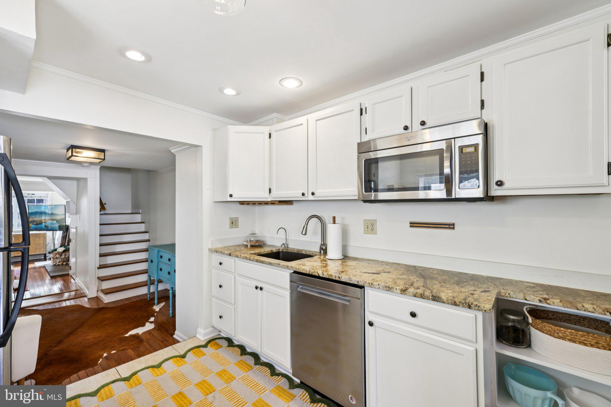 617 South Durham Street Baltimore, MD 21231 - Photo 8 of 42 a kitchen with stainless steel appliances granite countertop a sink and a stove