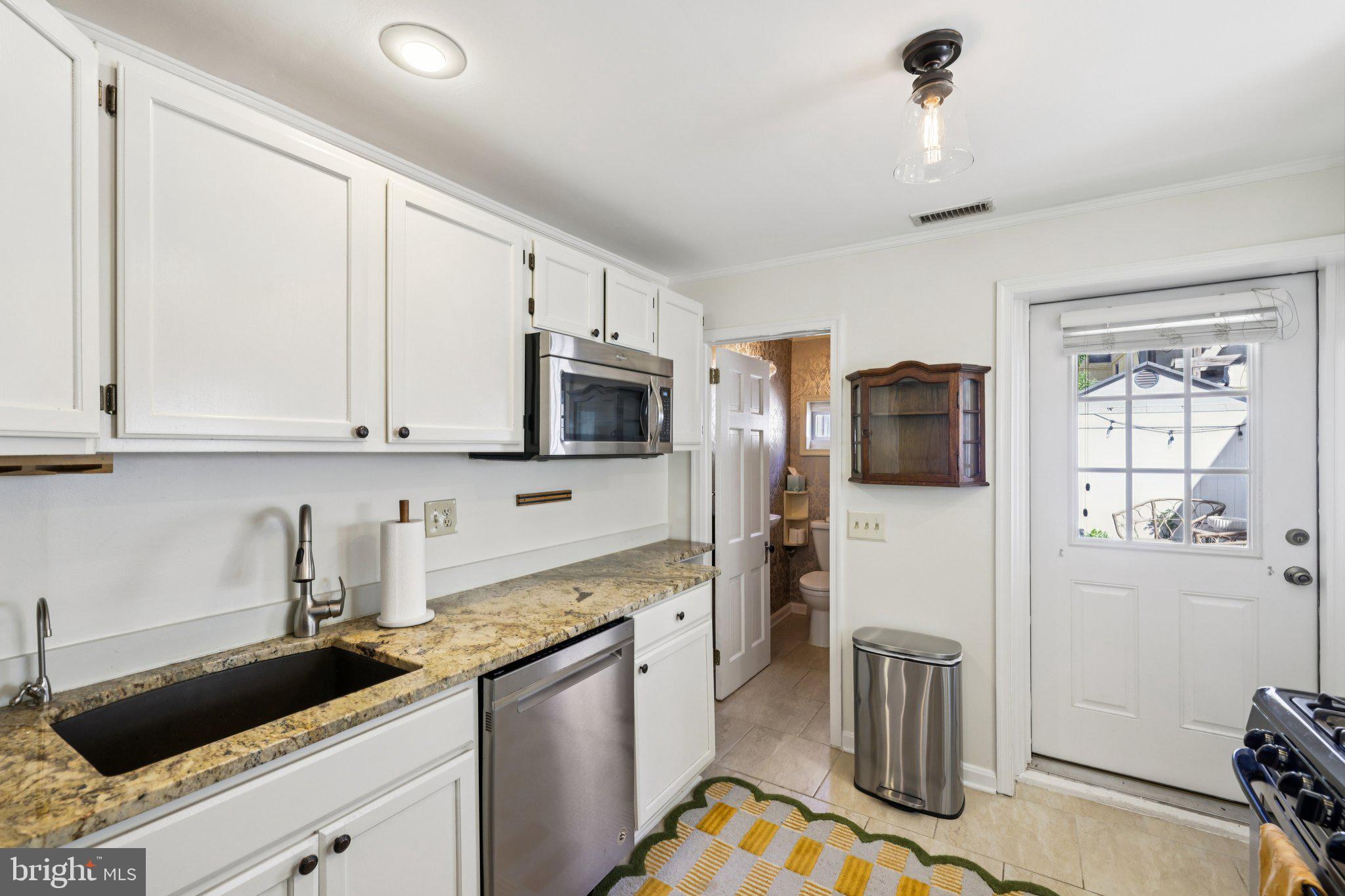 617 South Durham Street Baltimore, MD 21231 - Photo 10 of 42 a kitchen with stainless steel appliances granite countertop a refrigerator sink and stove