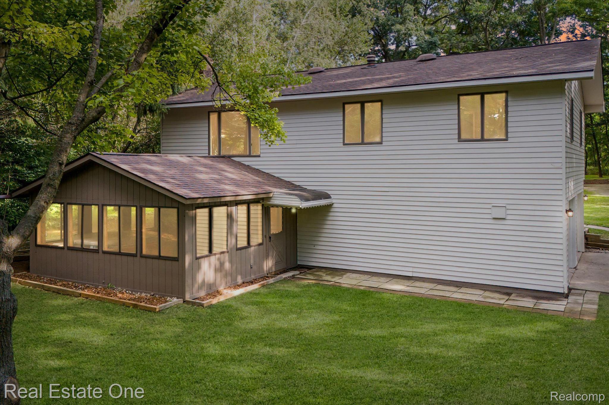 12160 Rattalee Lake Road Davisburg, MI 48350 - Photo 2 of 46 Back of home, 3 season room and walk-out.
