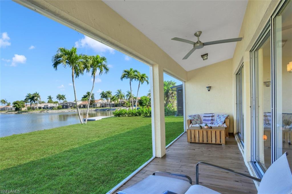 7311 Mill Pond Circle Naples, FL 34109 - Photo 12 of 22 a view of a chair and tables in the balcony