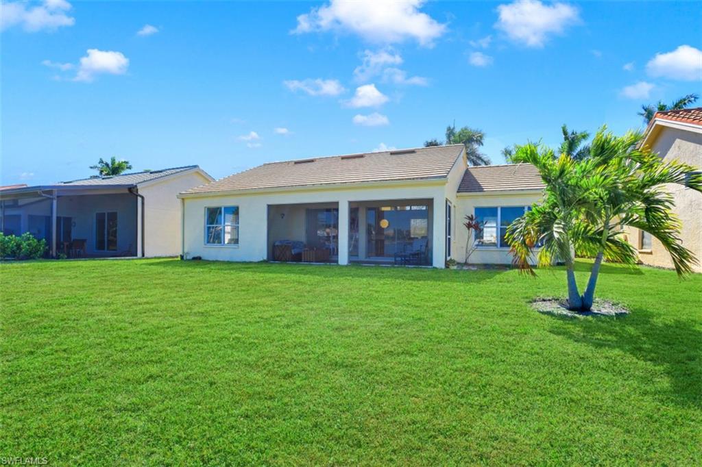 7311 Mill Pond Circle Naples, FL 34109 - Photo 21 of 22 a view of a house with a backyard