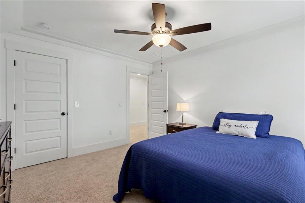 943 Clubside Drive Monroe, GA 30655 - Photo 54 of 93 a bedroom with a large bed and a chandelier