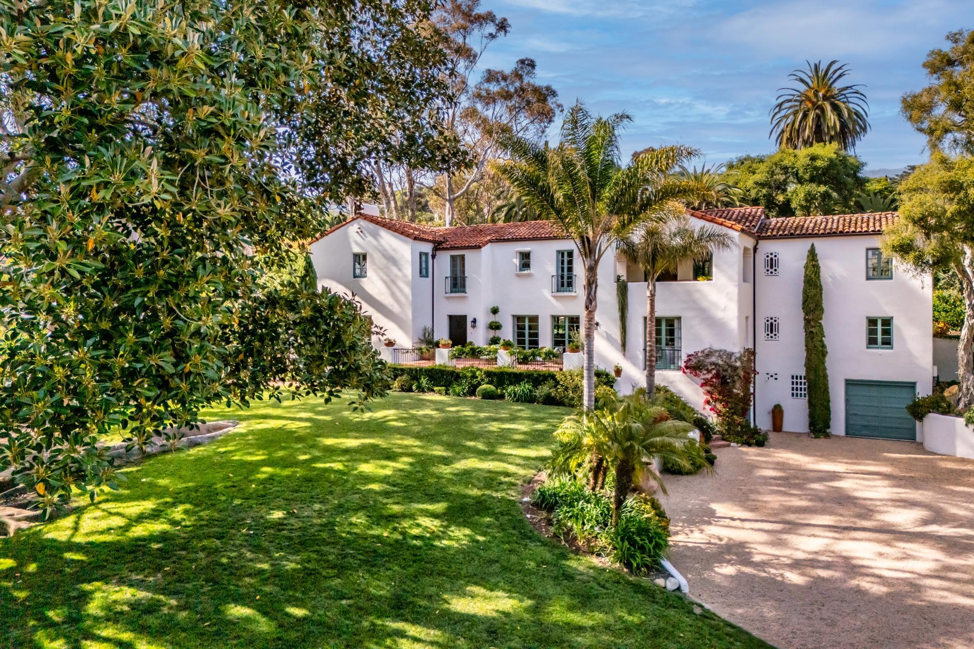a front view of a house with a yard table and chairs