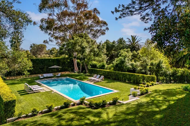 a view of a swimming pool and lounge chairs