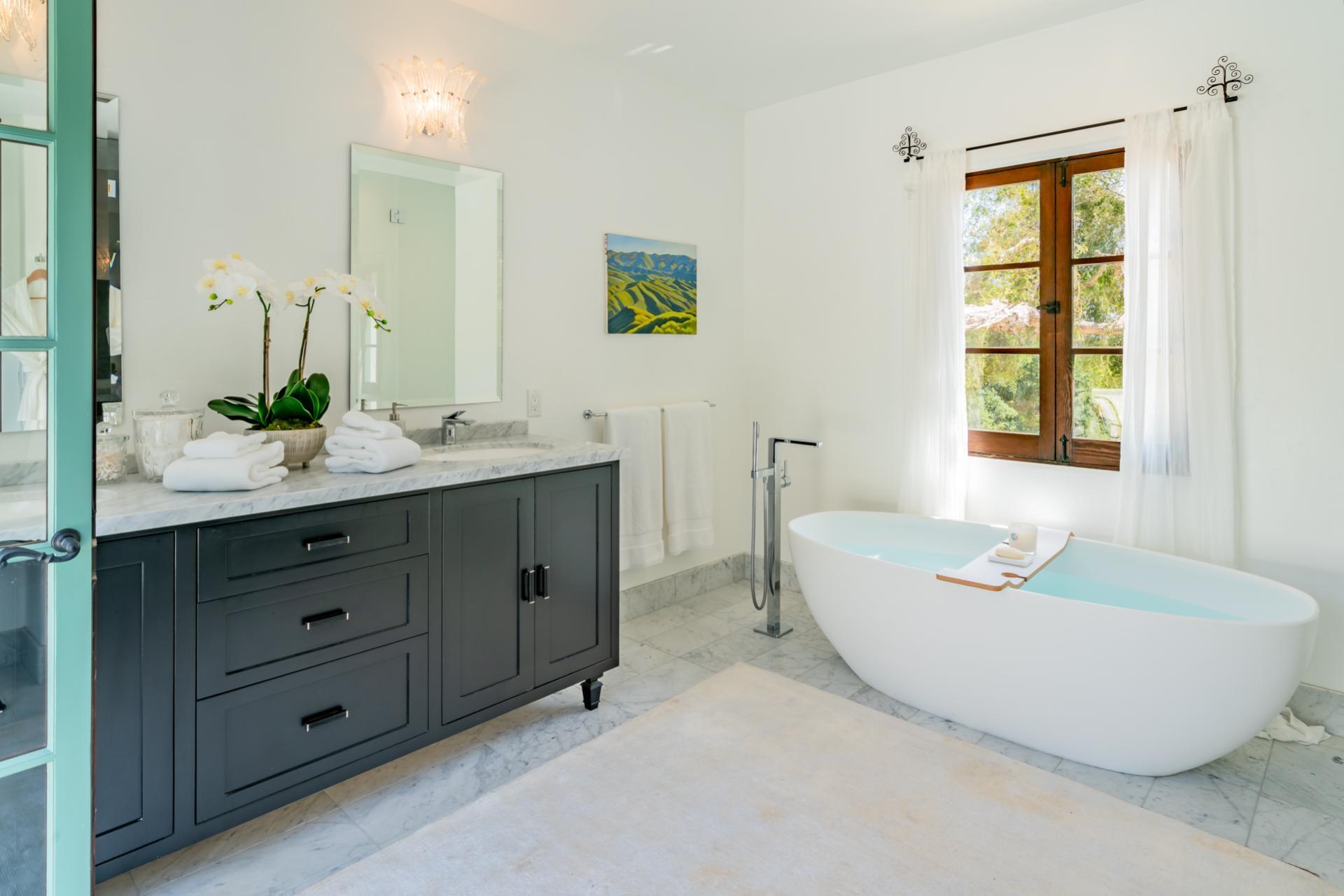 1098 Golf Road Montecito, CA 93108 - Photo 39 of 62 a bathroom with a double vanity sink tub and mirror