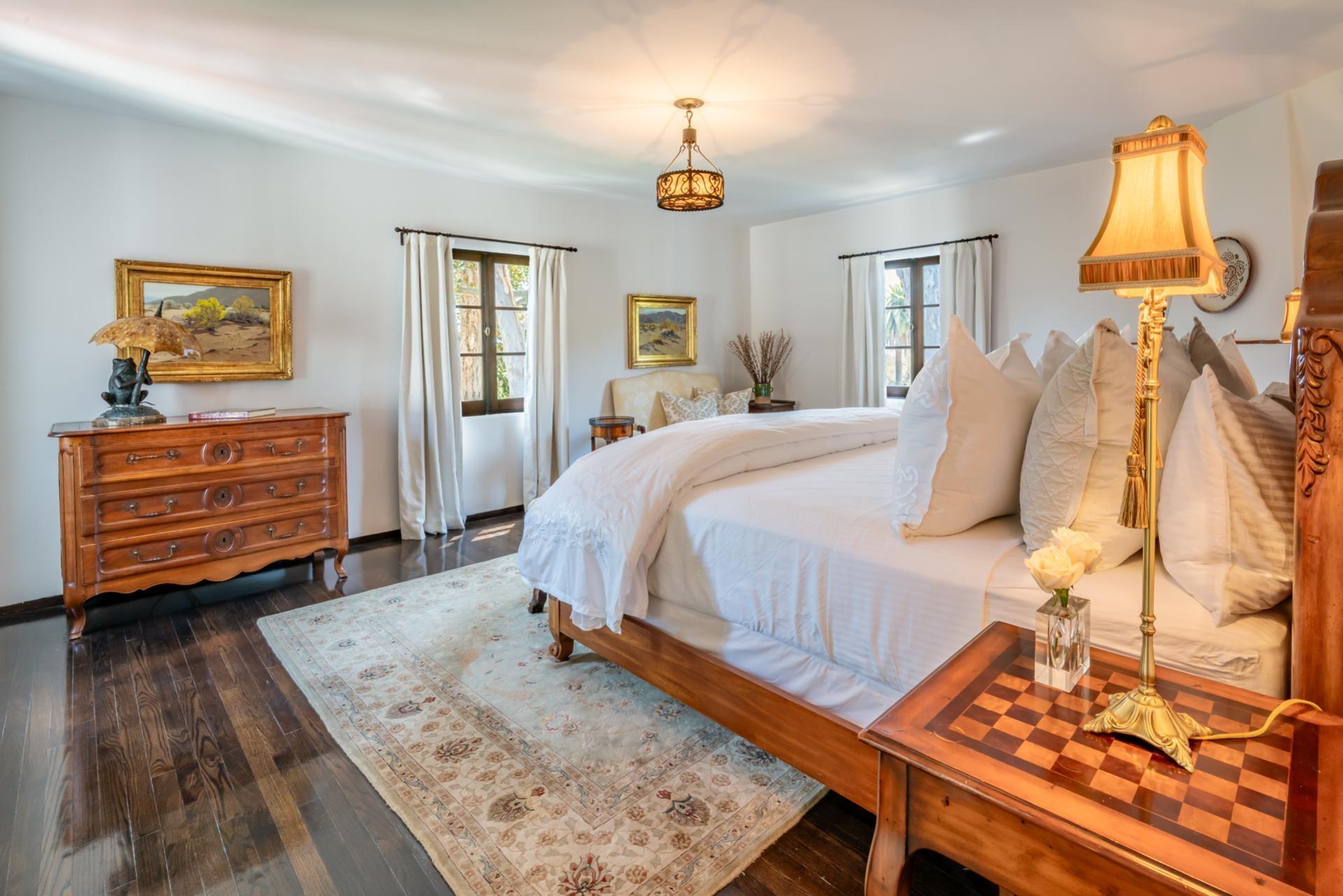 1098 Golf Road Montecito, CA 93108 - Photo 42 of 62 a bedroom with a bed and wooden floor