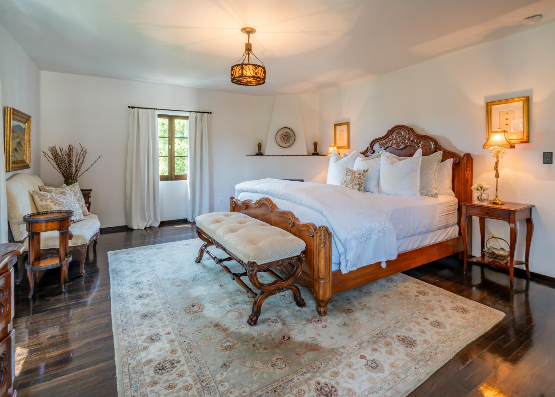 1098 Golf Road Montecito, CA 93108 - Photo 43 of 62 a bedroom with a bed and wooden floor